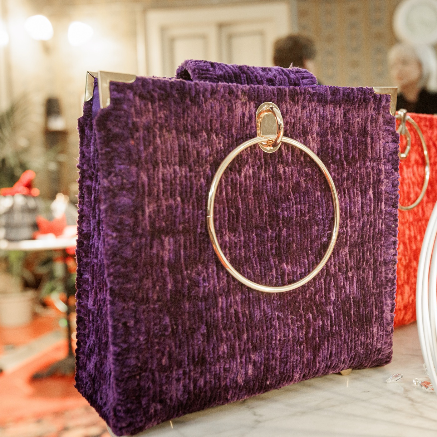 Purple crushed-velvet bag with gold ring handle