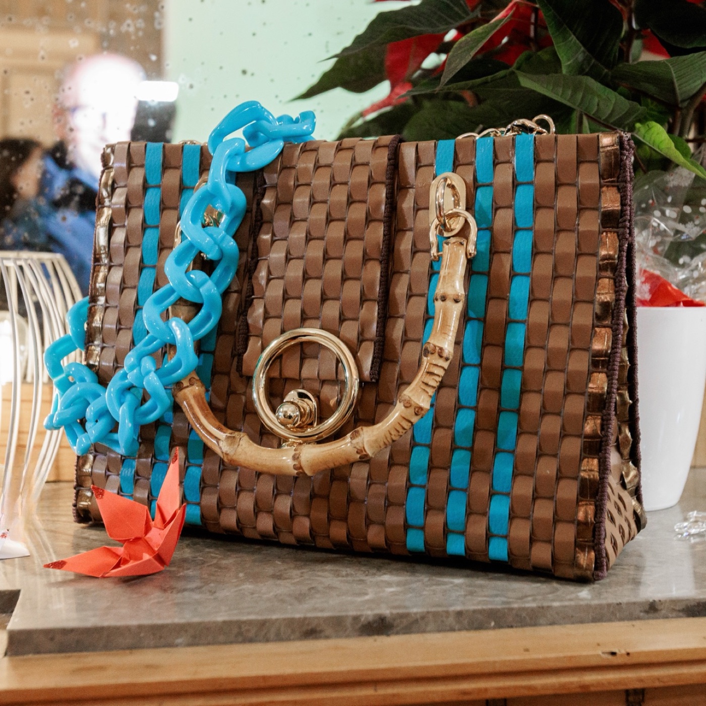 Hand-woven leather bag with bamboo handle and turquoise detail